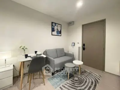 Modern living room with cozy sofa, stylish decor, and compact dining area in a contemporary apartment.
