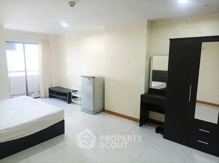 Spacious bedroom with modern furniture and natural light