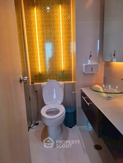 Modern bathroom with stylish lighting and glass sink