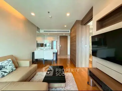 Modern living room with sleek furniture and open kitchen layout in a stylish apartment.