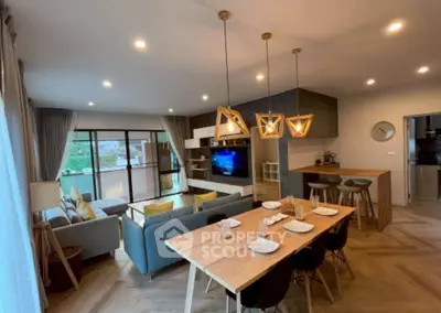 Modern open-plan living room with stylish decor and natural light