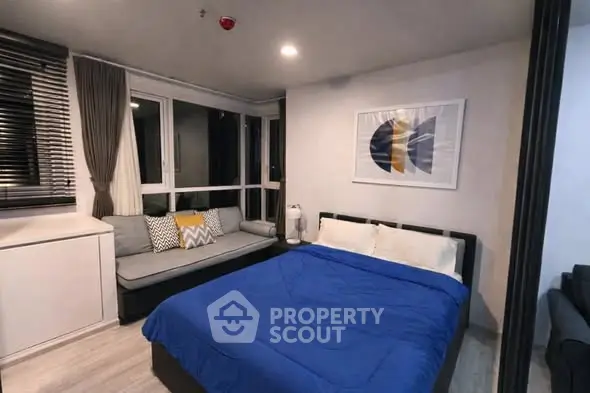 Modern bedroom with cozy seating area and stylish decor