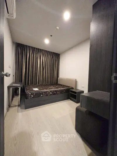 Modern bedroom with sleek design and cozy ambiance, featuring a comfortable bed and stylish furnishings.