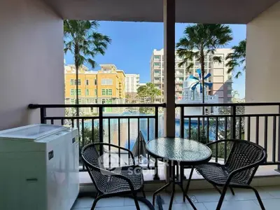 Charming balcony with pool view, perfect for relaxation and outdoor dining.