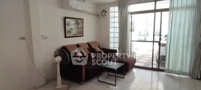 Spacious living room with modern sofa and large window for natural light