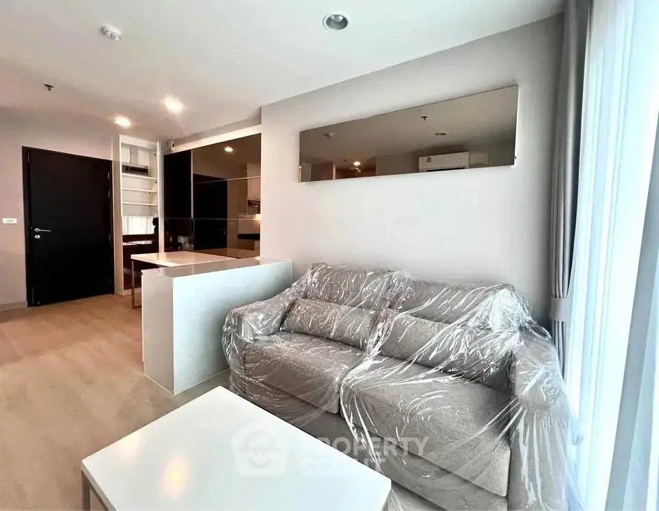 Modern living room with sleek design and natural light, featuring a cozy sofa and stylish decor.