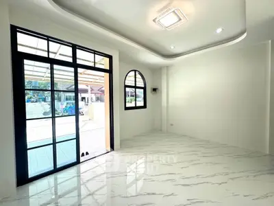 Spacious modern living room with large windows and elegant marble flooring