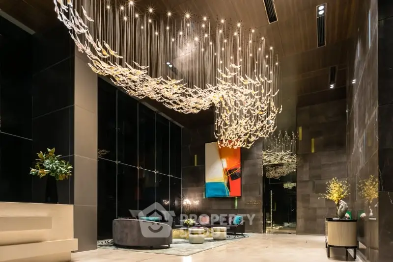Luxurious modern living room with stunning chandelier and contemporary art.