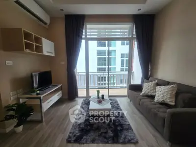 Modern living room with balcony view, stylish decor, and cozy ambiance in urban apartment.
