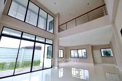 Spacious modern living room with high ceilings and large windows
