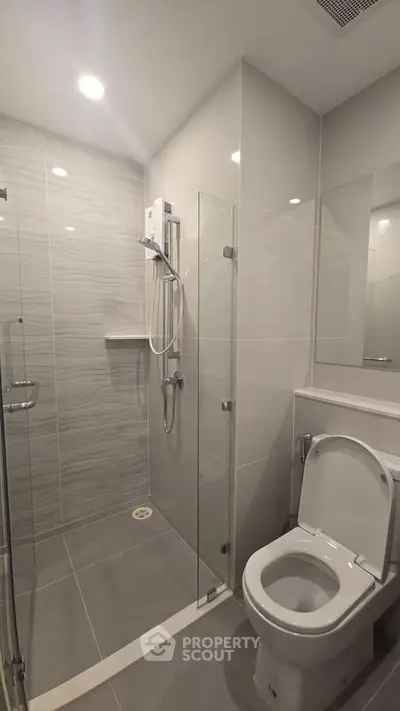 Modern bathroom with sleek shower and toilet in contemporary design