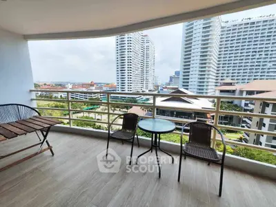 Spacious balcony with city view in modern high-rise apartment.