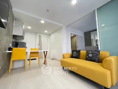 Modern living room with yellow sofa and dining area in open layout apartment.