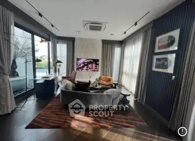 Luxurious living room with modern decor and large windows offering natural light.