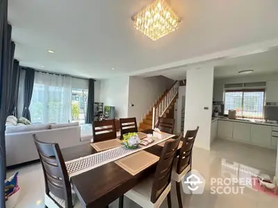 Spacious open-plan dining and living area with modern decor and natural light.