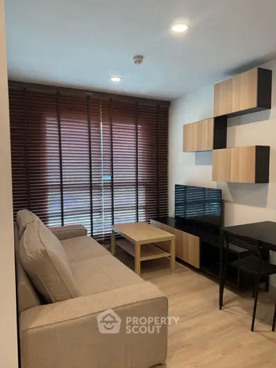 Modern living room with stylish furniture and wooden blinds