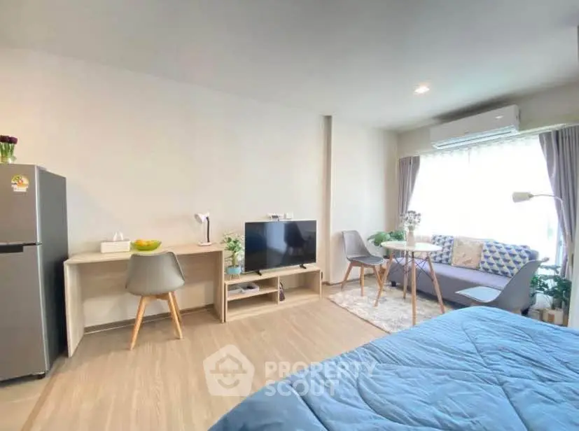Modern studio apartment with cozy living area and stylish decor