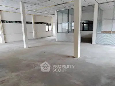 Spacious commercial space with open layout and large windows for natural light.