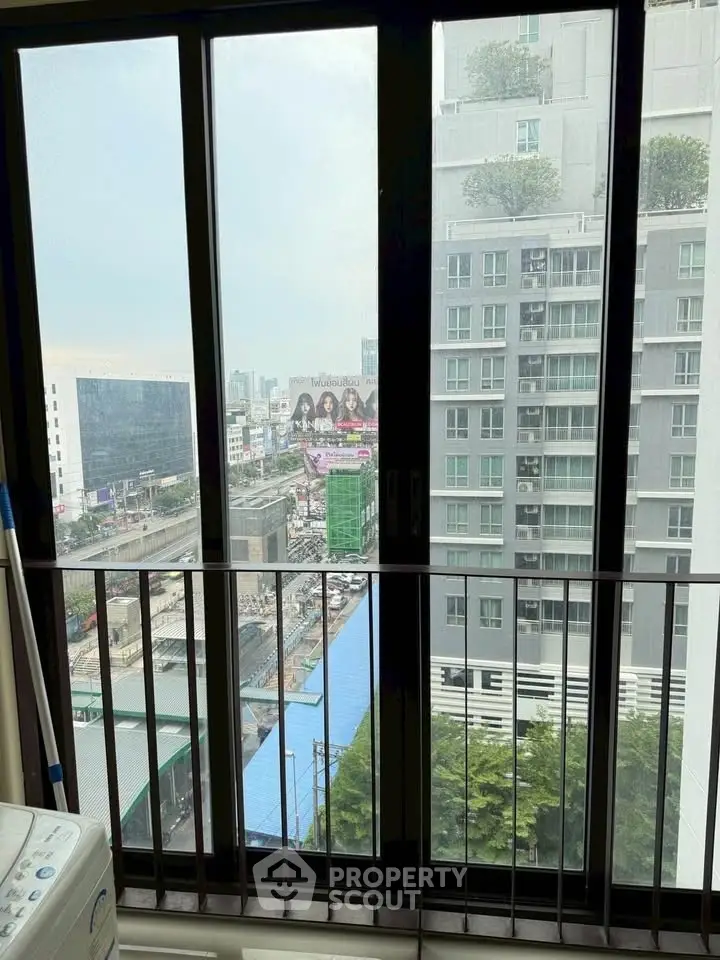 High-rise apartment view with cityscape and balcony, perfect for urban living.