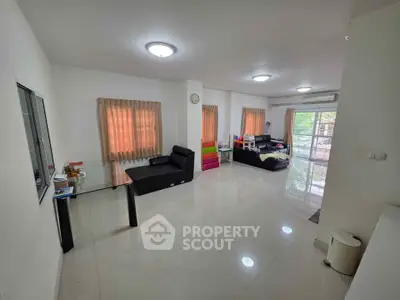 Spacious living room with modern furniture and large windows for natural light.