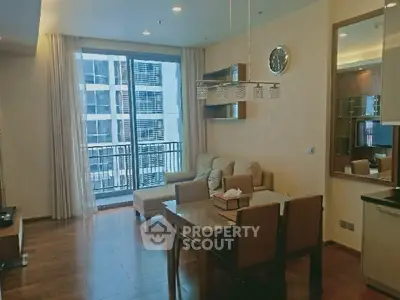 Modern living room with elegant dining area and balcony view in upscale apartment.