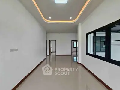 Spacious modern living room with sleek design and large windows