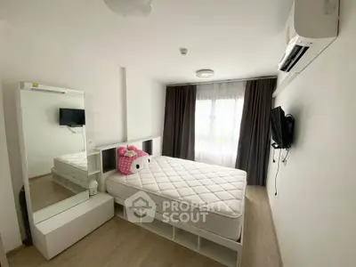 Modern bedroom with large window, air conditioning, and stylish decor in a cozy apartment.