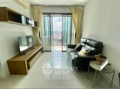 Modern living room with sleek furniture and city view from balcony