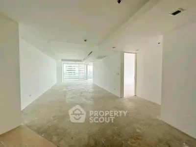 Spacious unfurnished living room with large windows and natural light