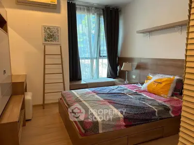 Cozy bedroom with modern wooden furniture and large window for natural light.