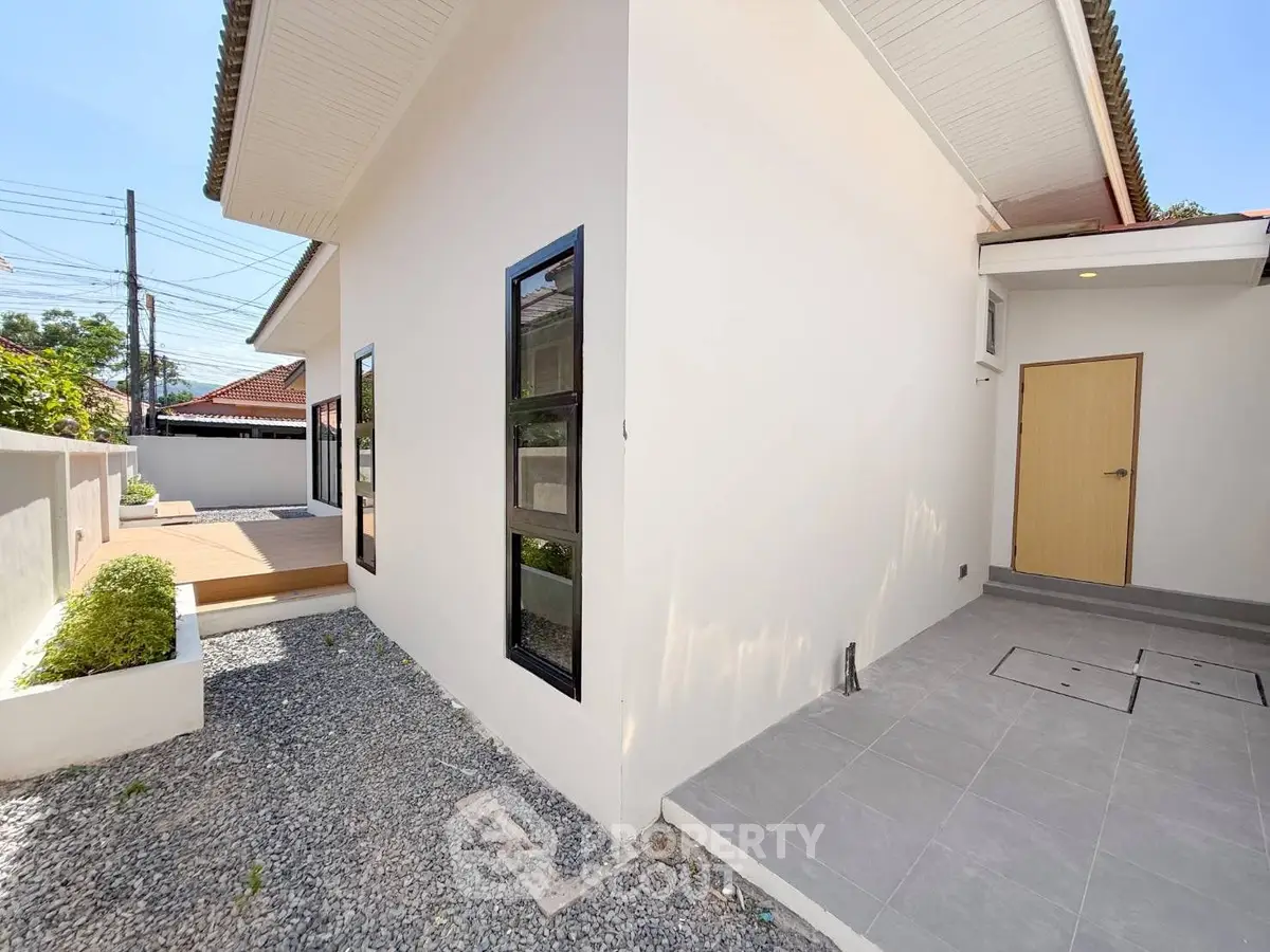 Modern exterior view of a single-story home with clean lines and a minimalist design.