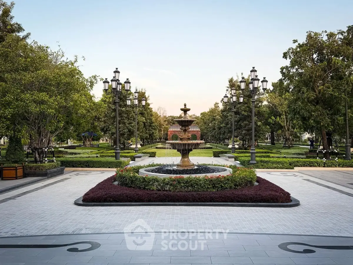 Elegant garden with central fountain and lush greenery in a serene setting.