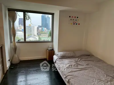 Modern bedroom with city view, featuring sleek design and cozy ambiance, perfect for urban living.