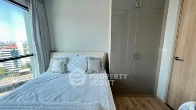 Cozy bedroom with city view and modern wardrobe
