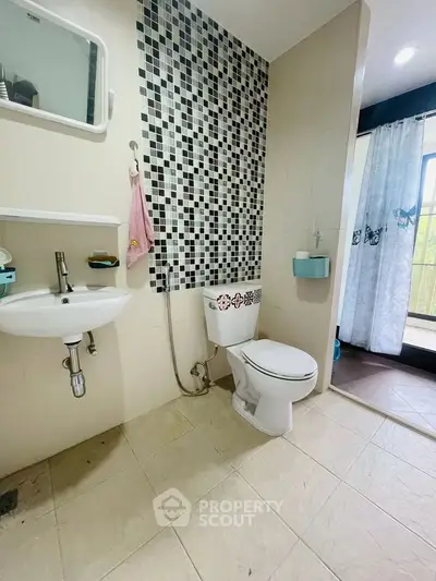Modern bathroom with stylish tile accent wall and balcony view