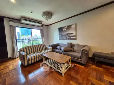 Spacious living room with stylish furniture and city view, perfect for modern urban living.
