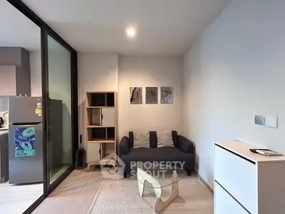 Modern living room with cozy sofa and stylish decor in open layout apartment.