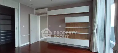 Modern empty living room with built-in shelves and large window view
