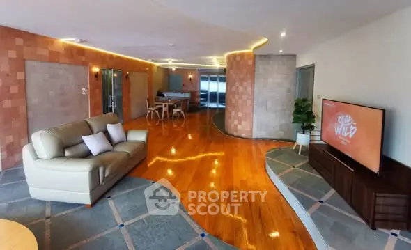 Spacious modern living room with stylish decor and wooden flooring, perfect for relaxation and entertainment.
