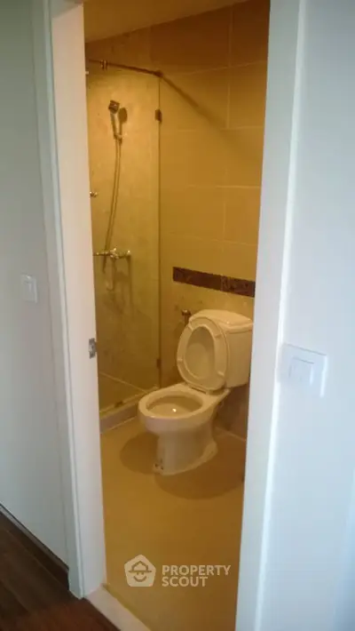 Modern bathroom with glass shower and sleek design in a contemporary apartment.