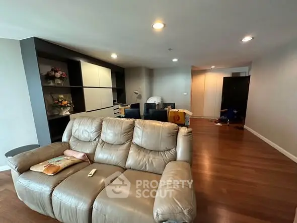 Spacious living room with modern decor and comfortable seating in a stylish apartment.