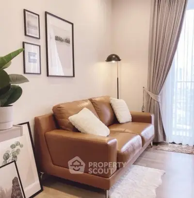 Chic living room with leather sofa, stylish decor, and natural light.