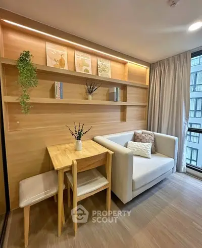 Cozy living room with modern decor and natural light in a stylish apartment.