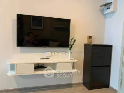 Modern living room with wall-mounted TV and sleek storage unit, perfect for contemporary living.