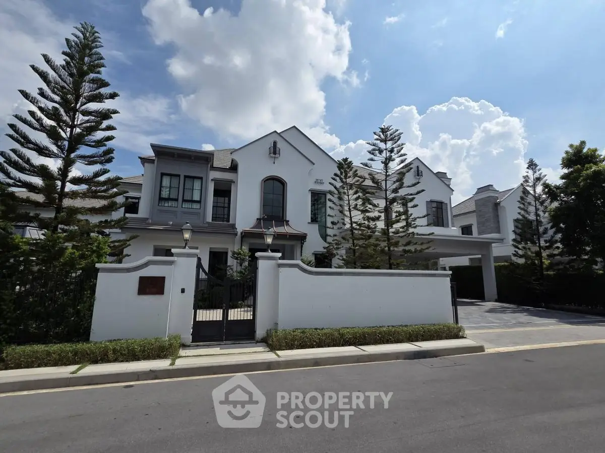Luxurious modern villa with elegant architecture and lush landscaping under a bright blue sky.