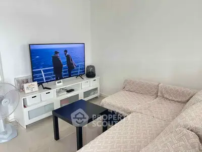 Cozy living room with modern TV setup and comfortable sofa