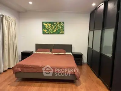 Spacious bedroom with modern decor and ample storage space