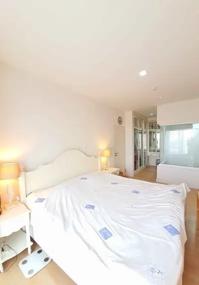 Spacious bedroom with elegant decor and ample natural light