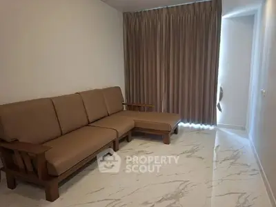 Spacious living room with elegant marble flooring and comfortable seating
