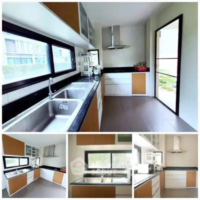 Modern kitchen with sleek design, featuring dual sinks and ample natural light.